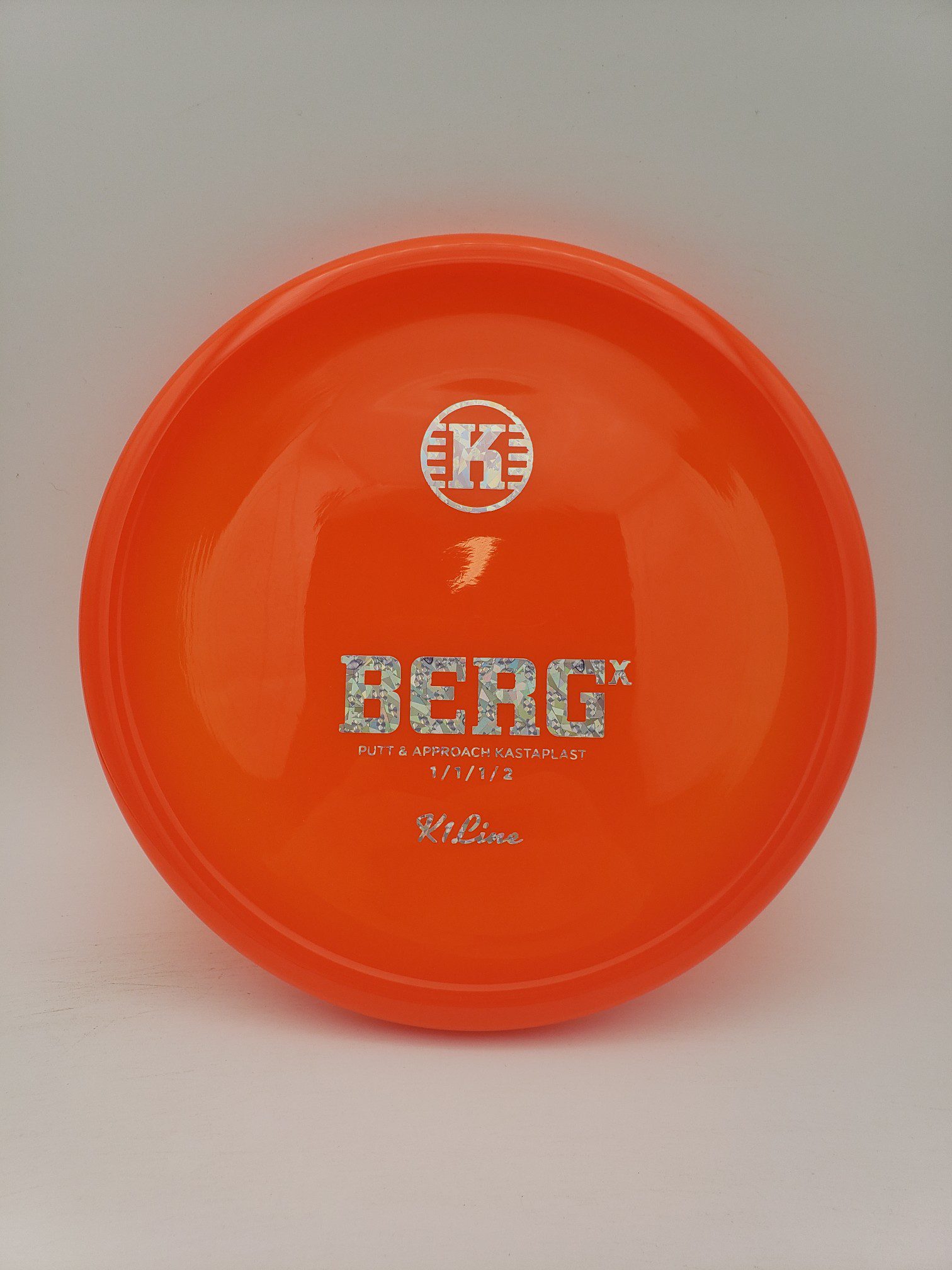Kastaplast K1 Berg X translucent orange disc golf disc front view